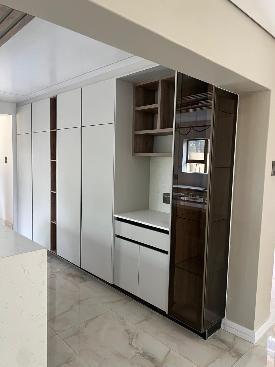 Full-Height Storage Wall with Bronze Glass Tower